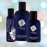 Three dark blue bottles of Sliquid Satin Personal Moisturizer & Lubricant, a hypoallergenic water-based product enriched with aloe vera, are showcased against a soft gradient backdrop. The labels present white floral designs and include product details.